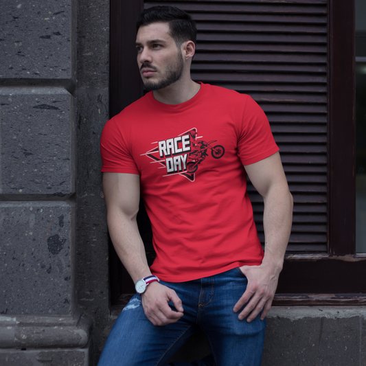Man wearing a red 'Race Day' t-shirt leaning against a stone wall.