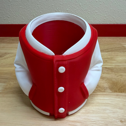 Red and white neck brace on a wooden surface with a plain wall background