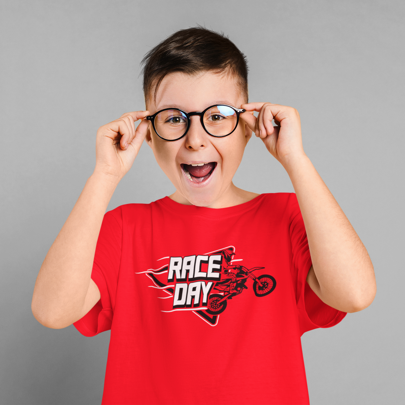 Child wearing a red 'Race Day' t-shirt with a gray background